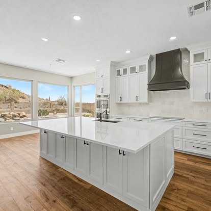Angled view of finished white kitchen island and cabinetry