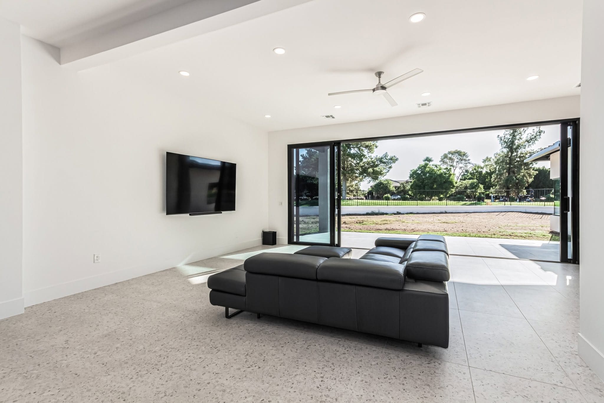 Bright completed living space with wide glass doors and refined tilework